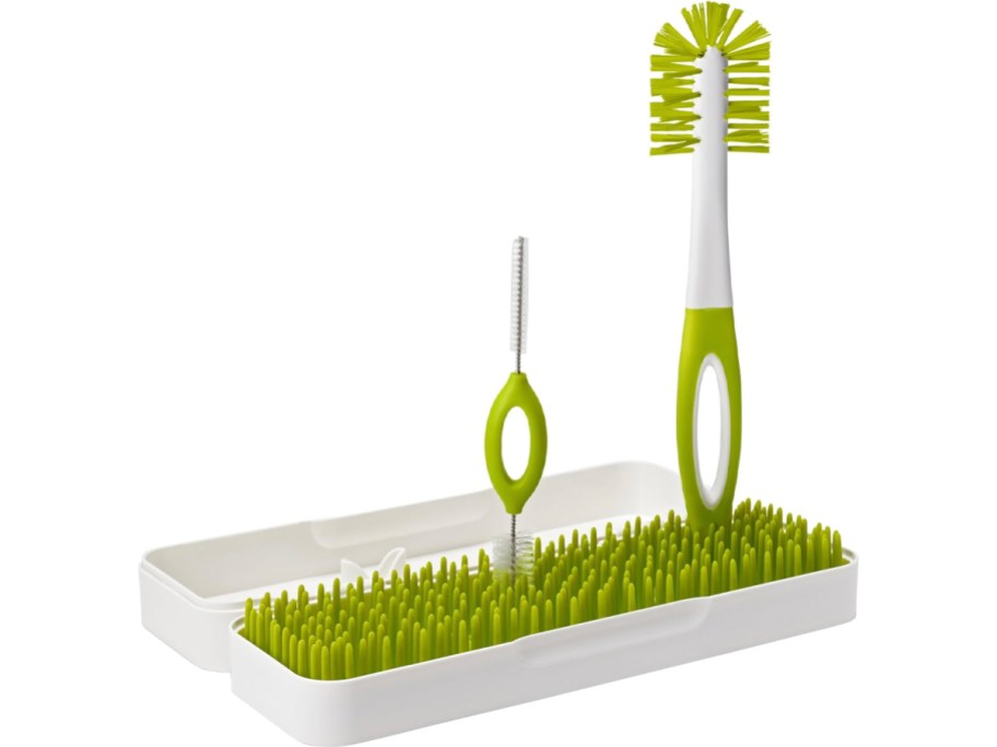 green and white bottle cleaning grass holder and cleaning brush