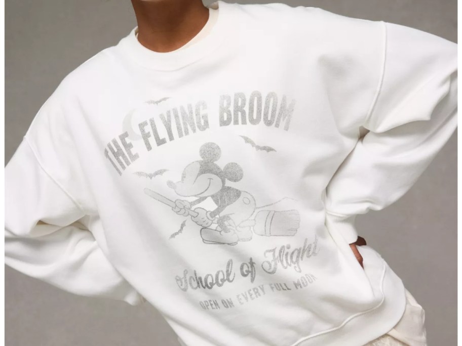 woman wearing a Mickey Mouse Halloween sweatshirt