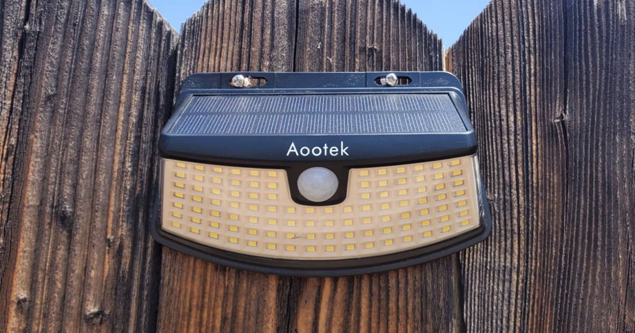 solar light hanging on a fence post