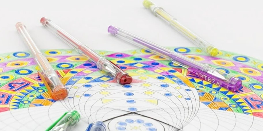 gel pens laying on colored paper 