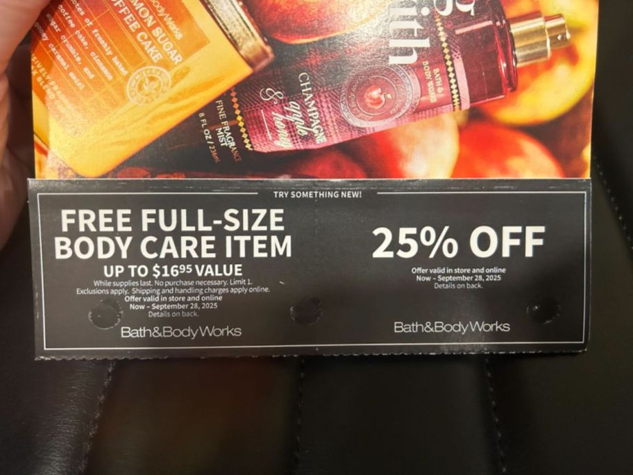 hand holding Bath & Body Works coupon mailer