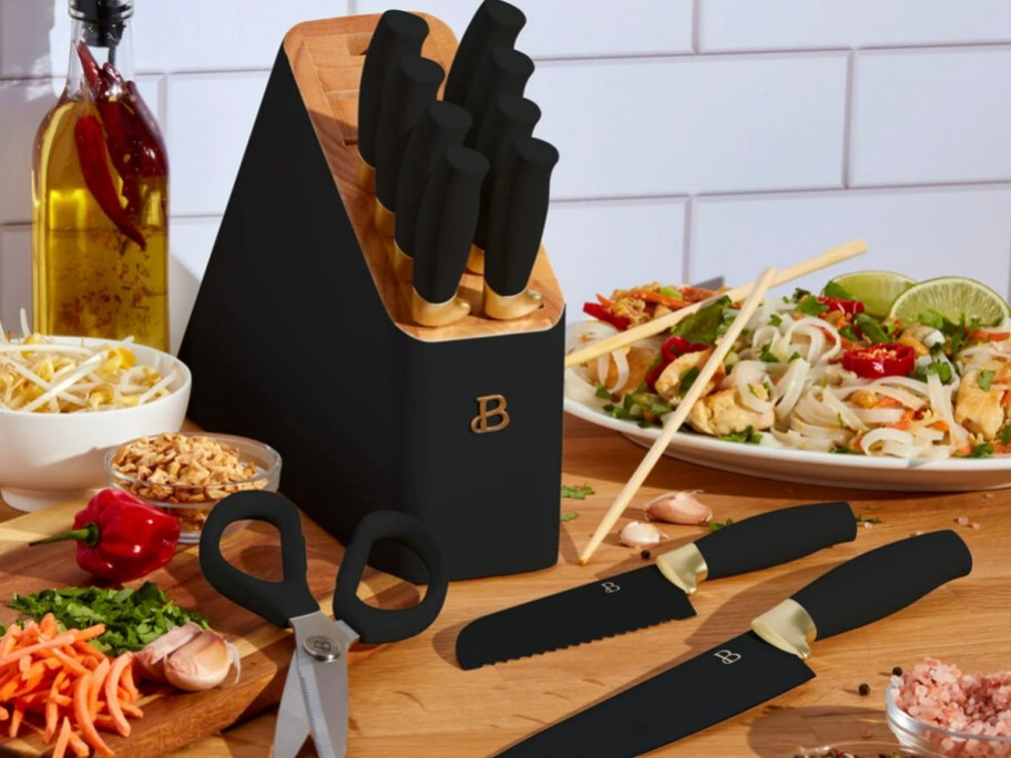 black knife block set on table with two knifes and scissors sitting in front