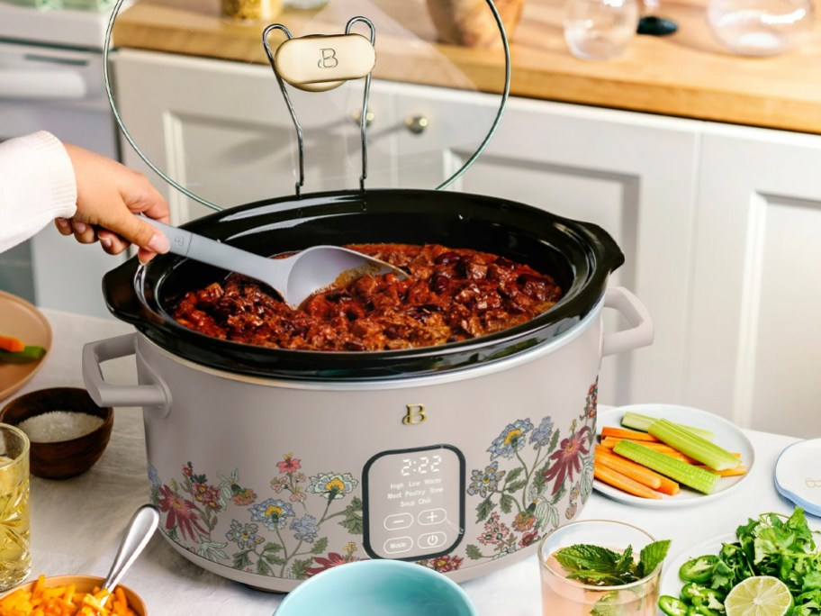 floral slow cooker with chili inside on counter