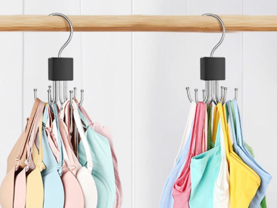 two hangers holding bras and tank tops in closet