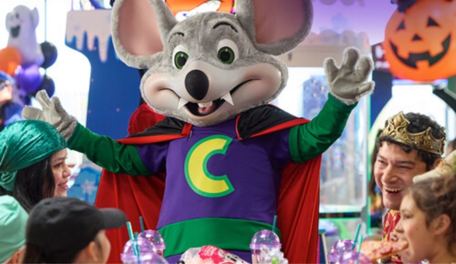 a person in a chuck e cheese costume wearing a vampire costume