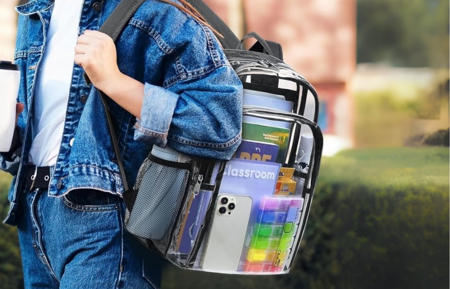 a girl carrying a filled clear backpack