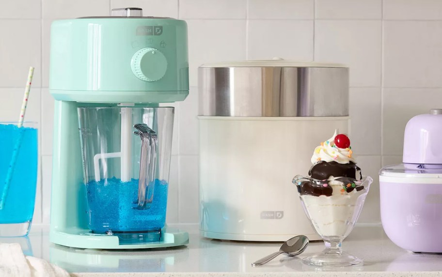 teal shaved ice maker with treats on counter