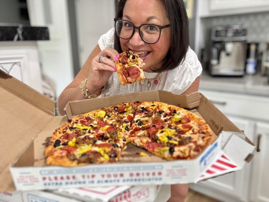 Woman eating a slice of pizza