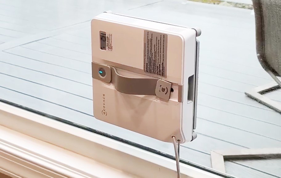 robot vacuum cleaning a window