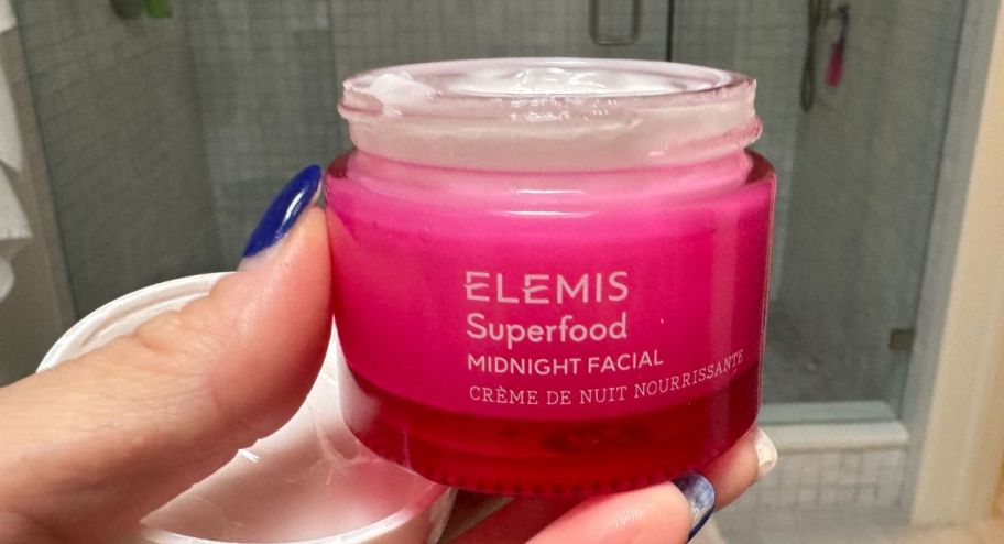 hand holding elemis night facial cream