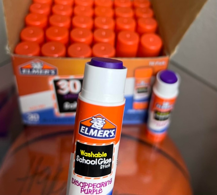 close up of purple glue stick and box of glue sticks