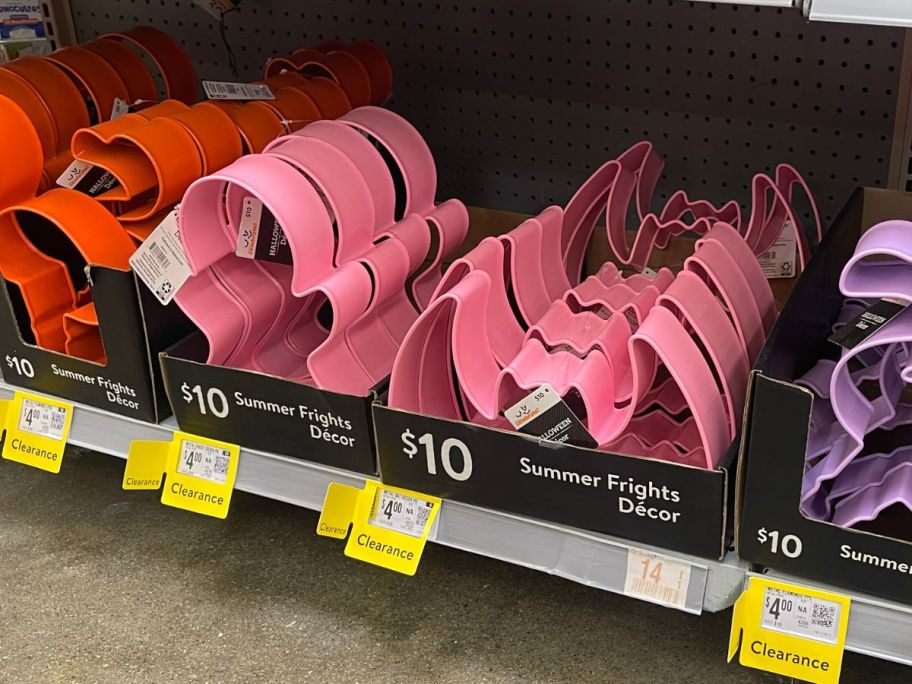pink bat shaped Halloween Metal Decor on shelf in store