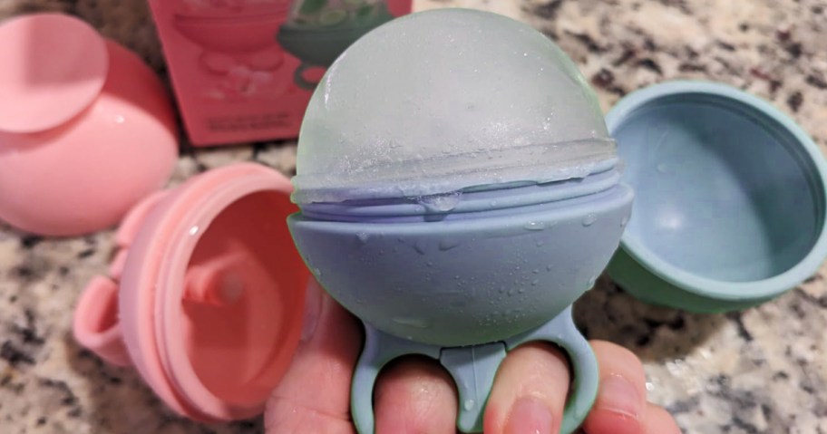 person holding an ice roller