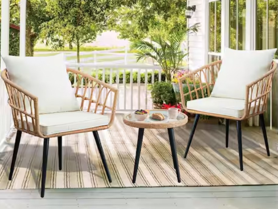 bohemian chairs and table with white cushions on patio 
