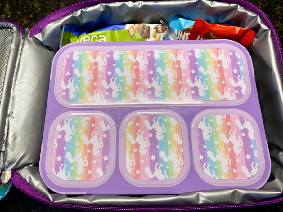rainbow unicorn bento box inside of an insulated lunch bag
