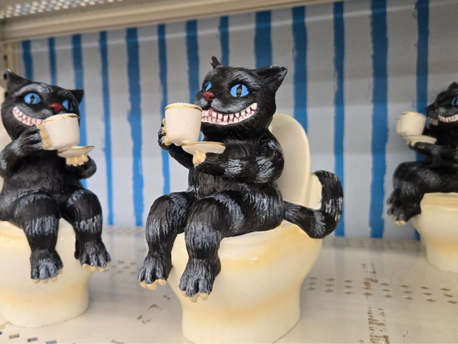Cheshire Cat on a Toilet figures on shelf in store