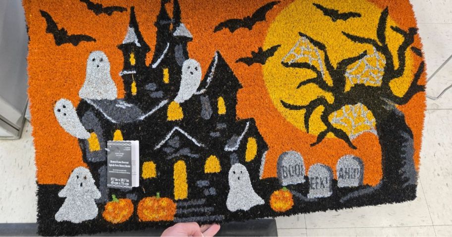 doormat with haunted house on it in store