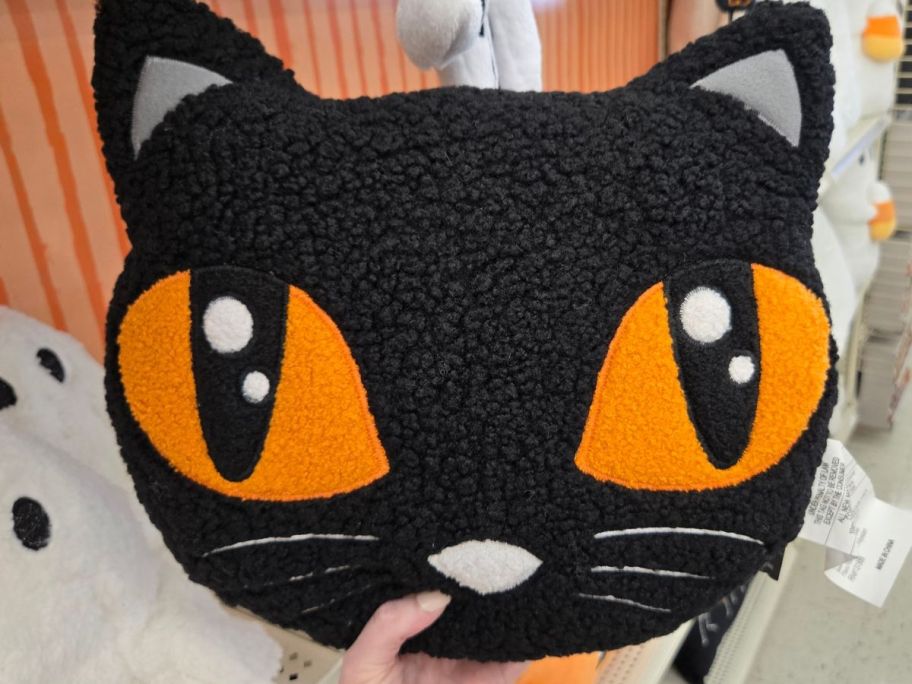 Black Cat Pillow in hand in store