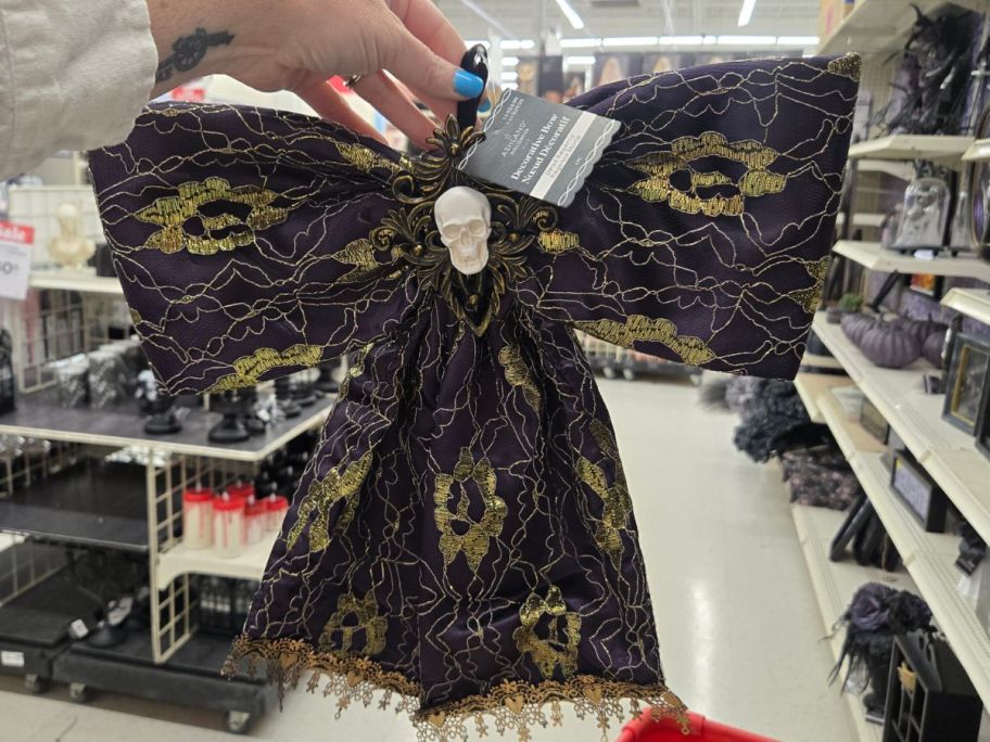 hand holding black and gold Padded Bow in store