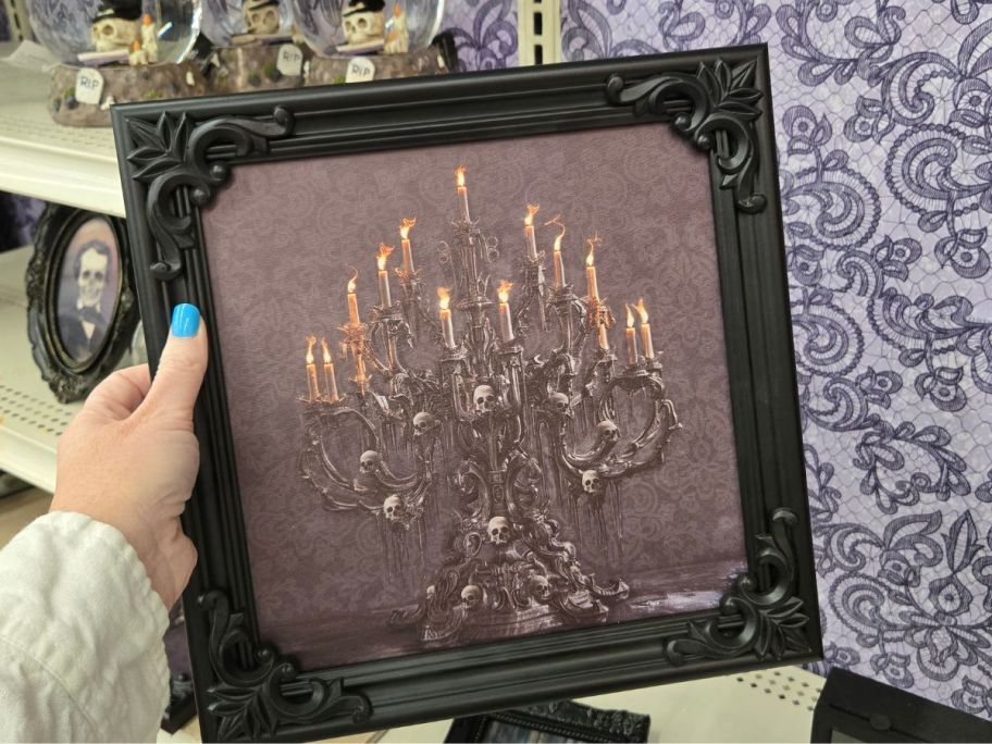 Skull Candelabra Canvas Wall Decor in hand in store