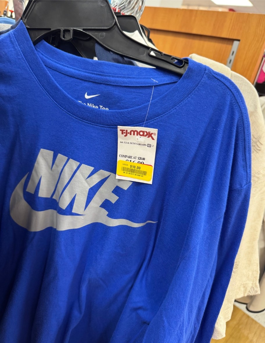 blue nike tee hanging on a store rack