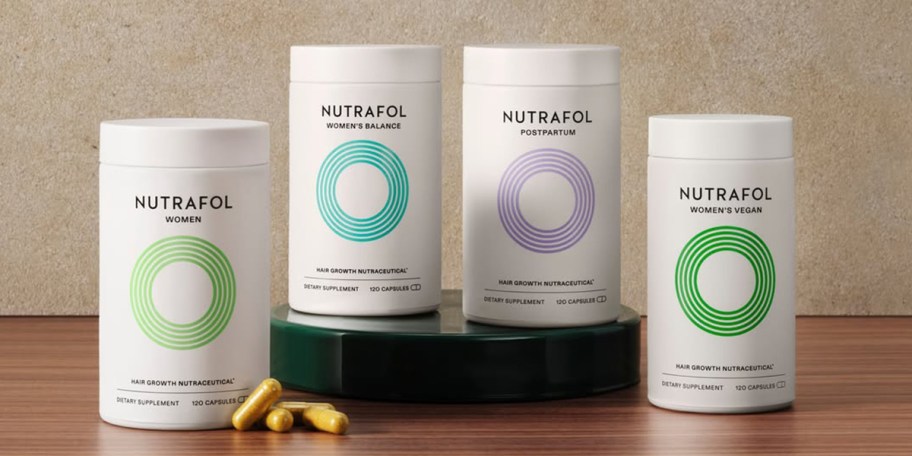 4 bottles of nutrafol supplements on table