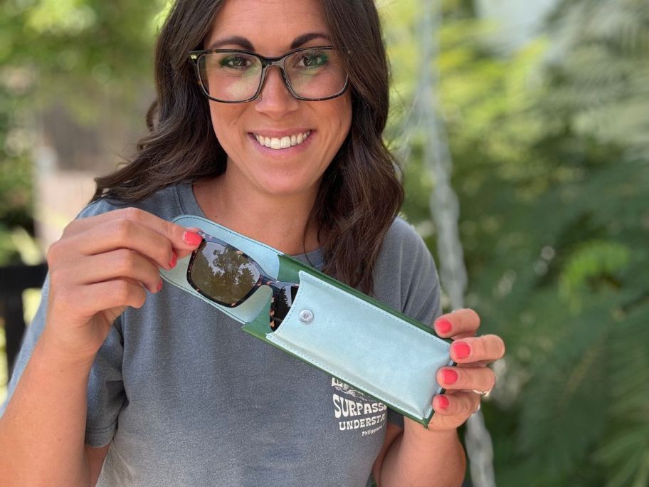 woman wearing black glasses putting toppers into glasses holder
