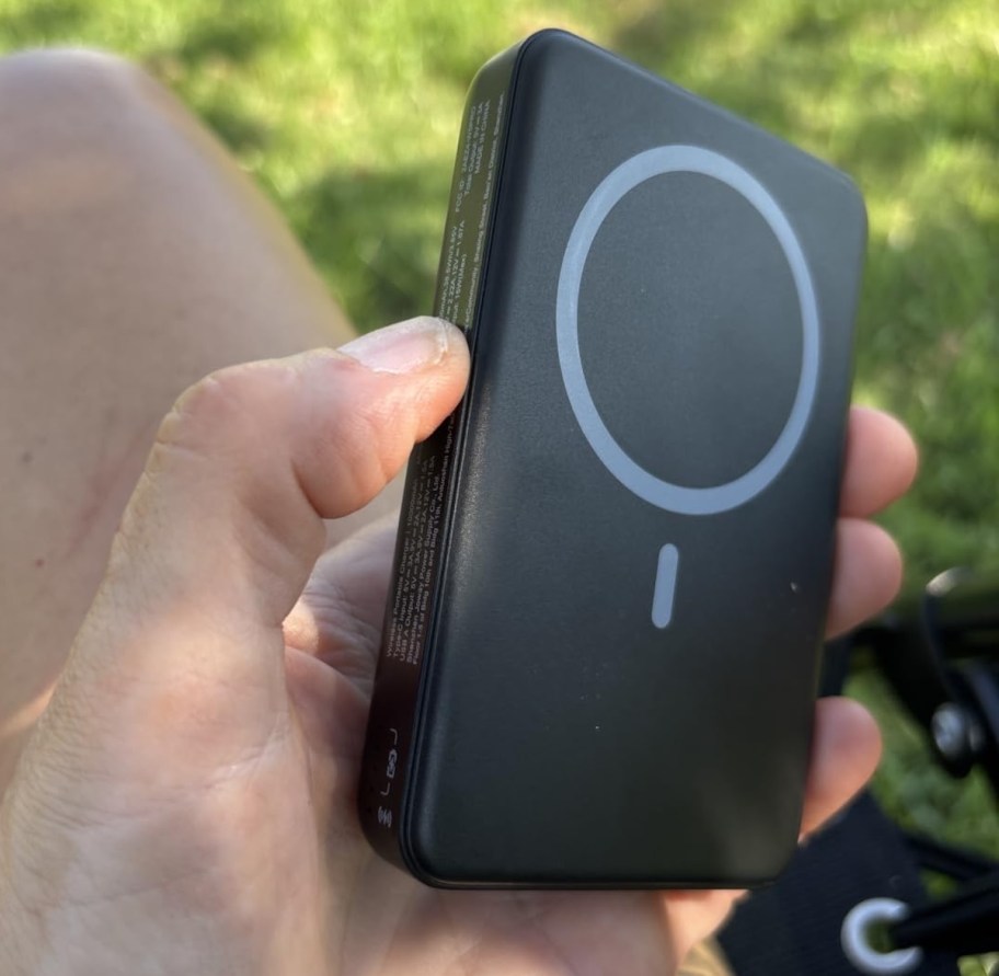 hand holding black portable power bank