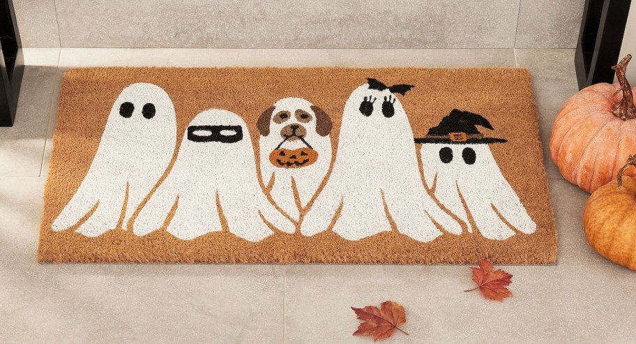 ghosts on doormat sitting in front of door
