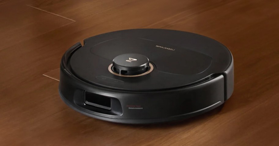 black roborock robot on hardwood floor