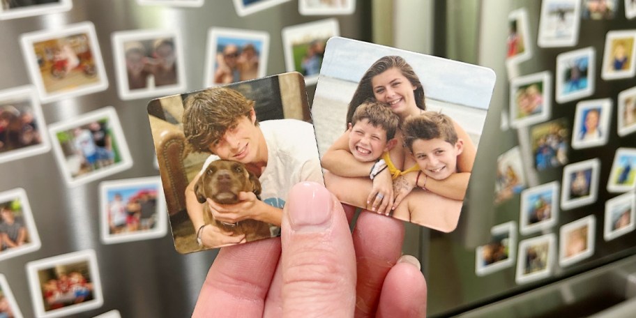 hand holding two photo magnets