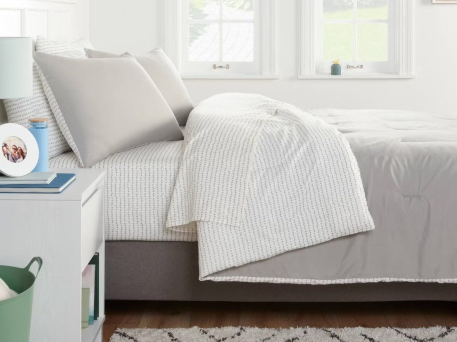 white and gray bedding in room 