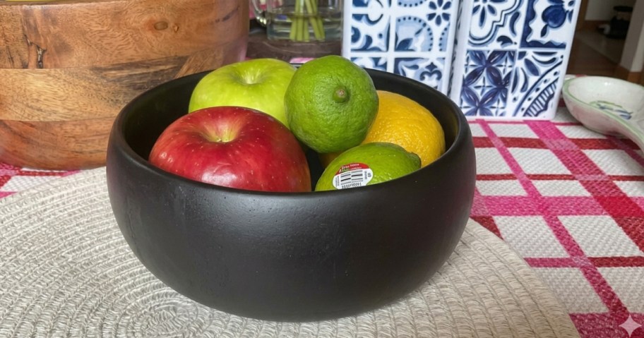black serving bowl filled with fruit