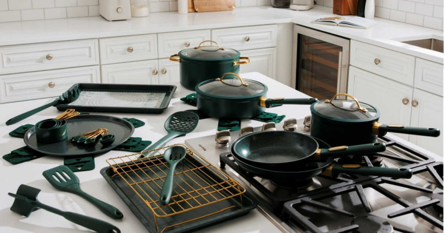 dark green thyme and table cookware set on a kitchen cooktop