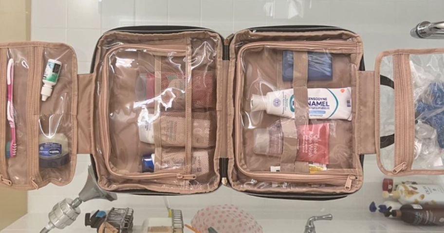 hanging toiletry bag laid out in bathroom