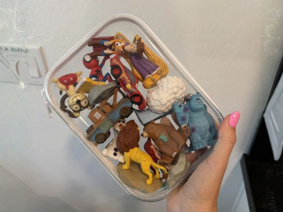 hand holding up&up Hard Sided Zipper Pencil Case with toys in it