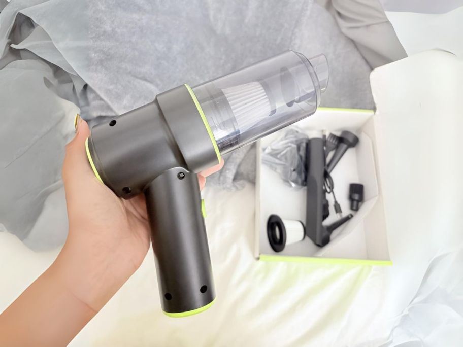 Holds a portable handheld vacuum