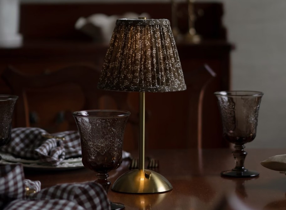 brown table lamp on dark table in dimmly lit room