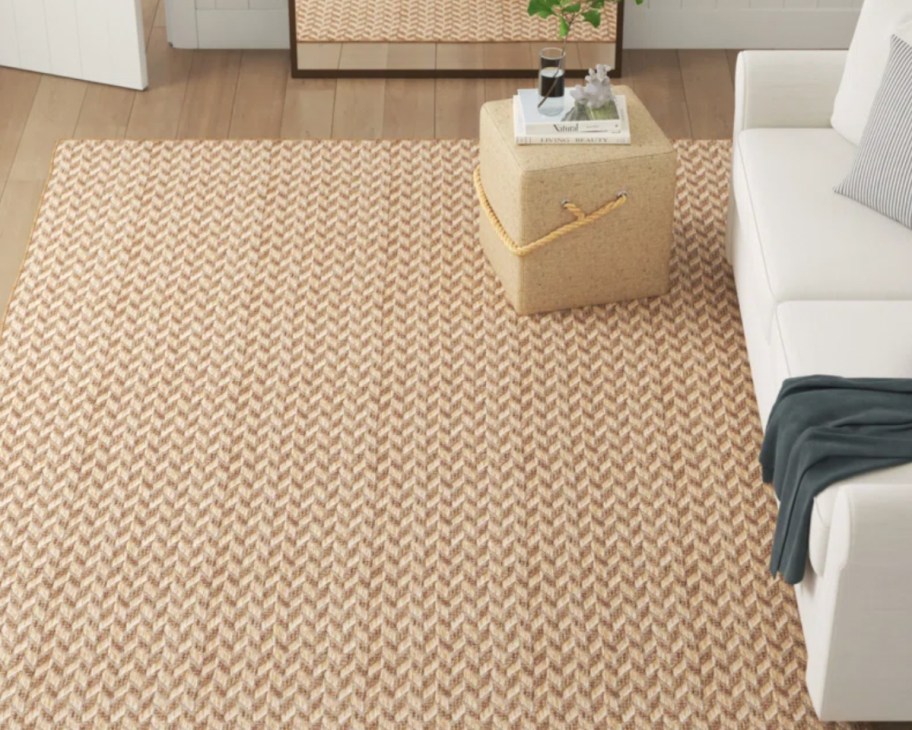 tan jute herringbone rug next to couch
