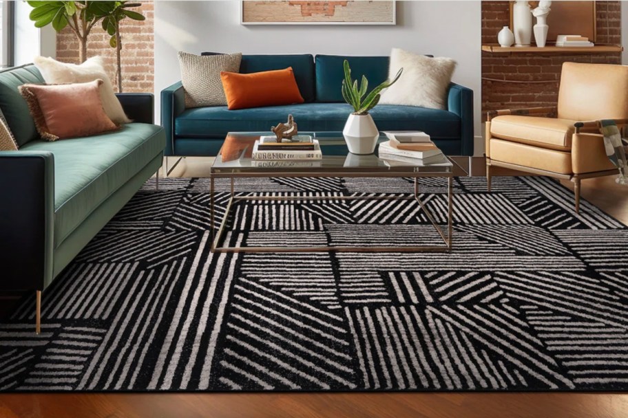 black and white geometric area rug next to couch and chair