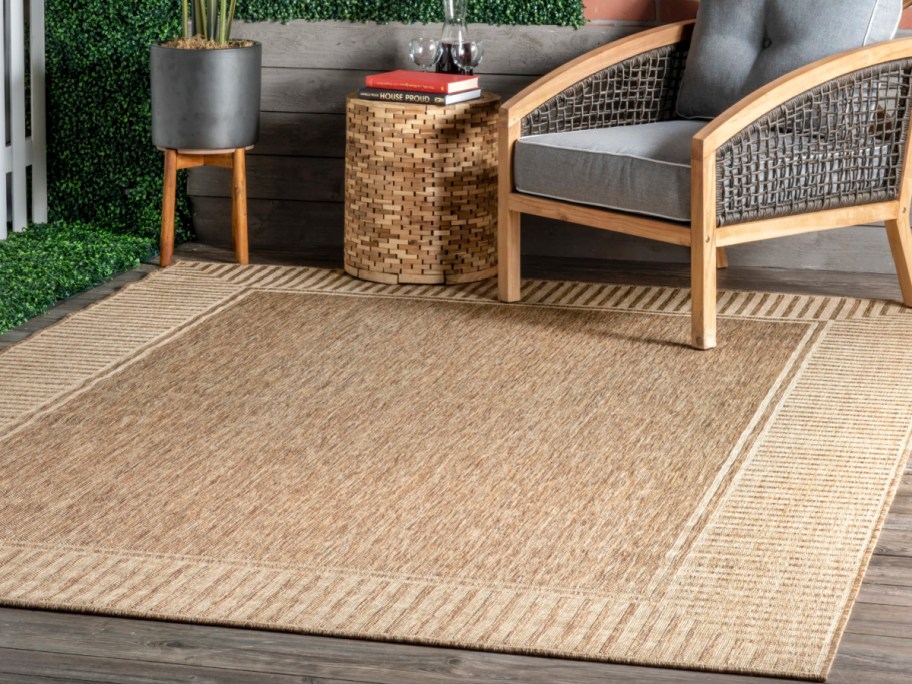 tan jute rectangle border area rug under chair