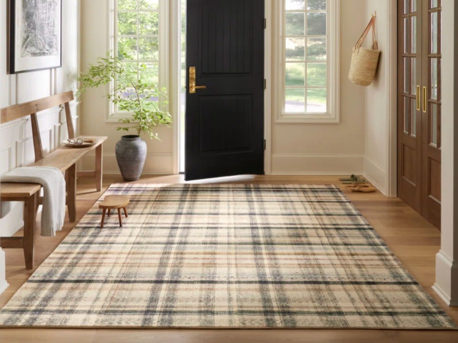 tan and green plaid area rug in entryway