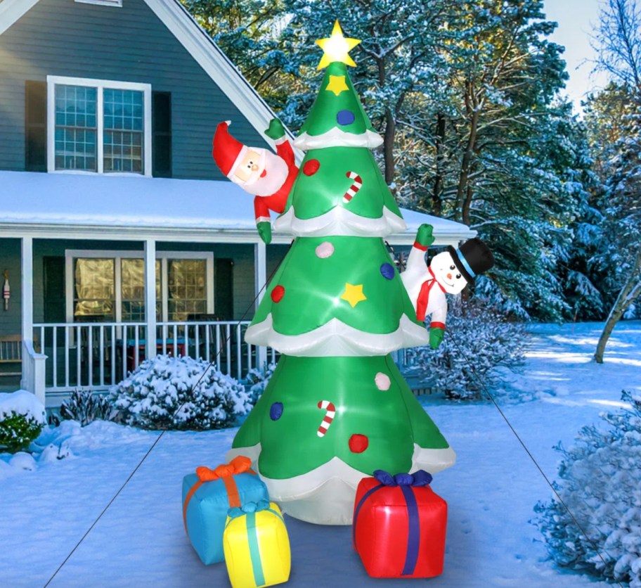 christmas tree inflatable with santa and snowman on it
