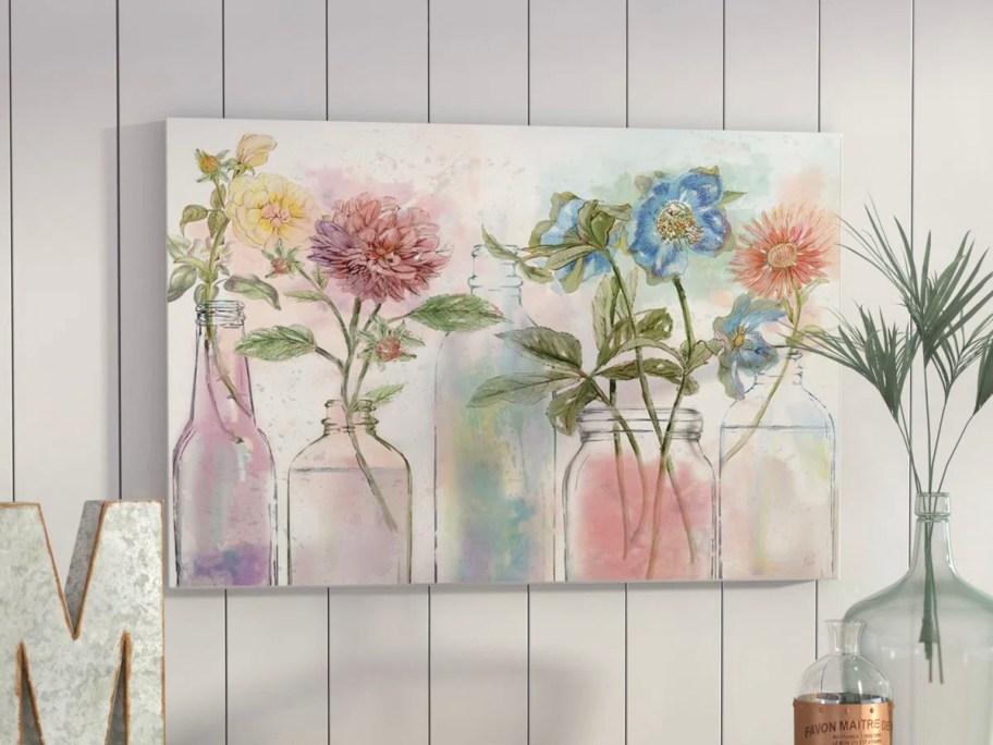 canvas print with flowers in vases hanging on wall 