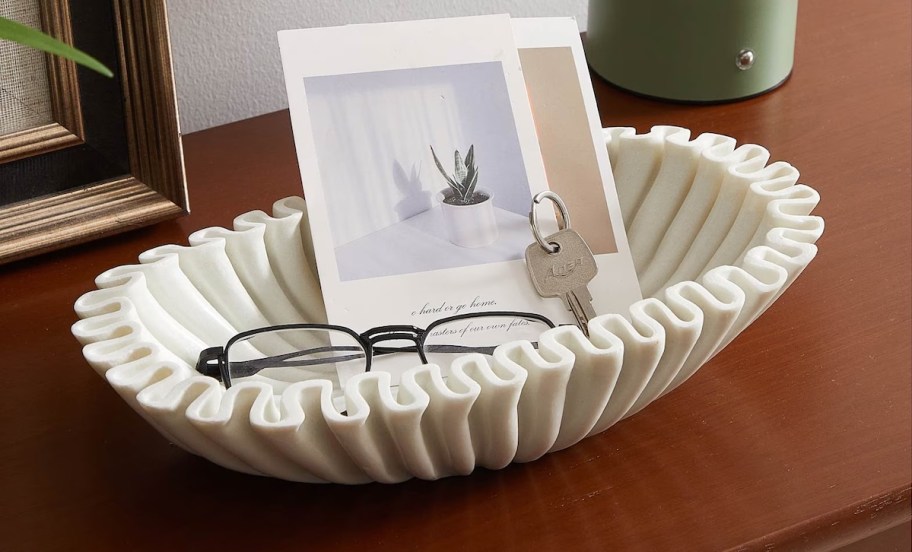 white fluted bowl with glasses and pictures