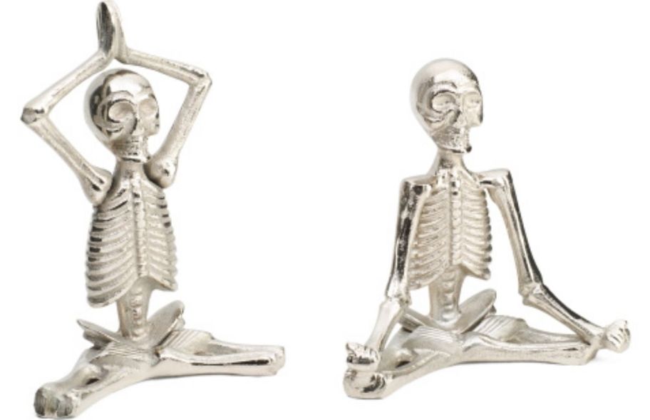 two silver yoga skeleton figurines