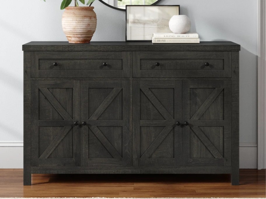 a black sideboard buffet cabinet in a living room