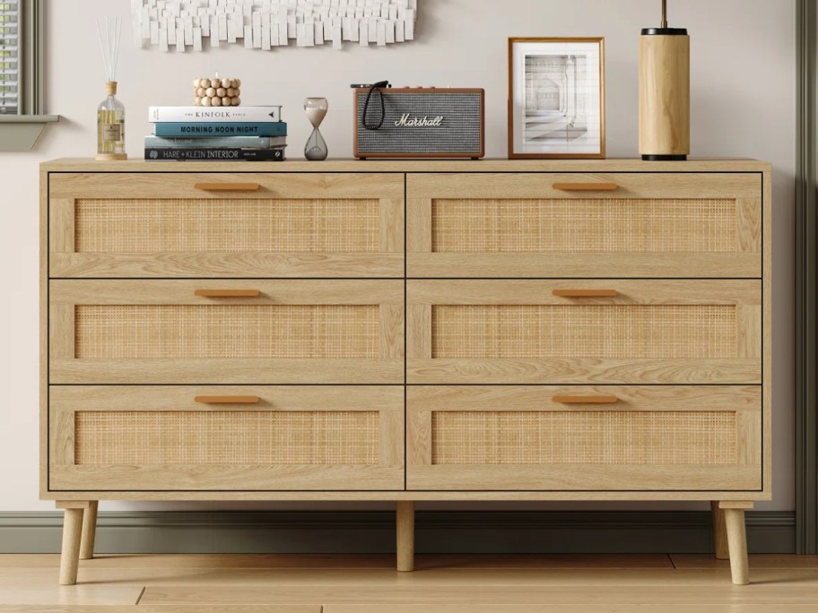 a 6 drawer rattan dresser in a bedroom