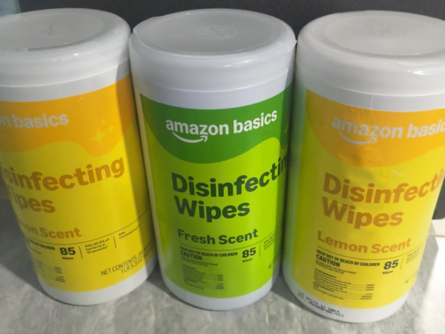 yellow and green containers of Amazon Basics Disinfecting Wipes
