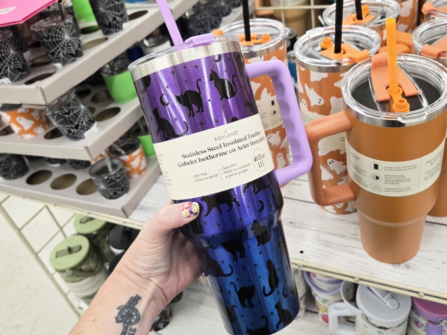 hand holding a purple and black Ashland 40oz Iridescent Cat Stainless Steel Insulated Tumbler